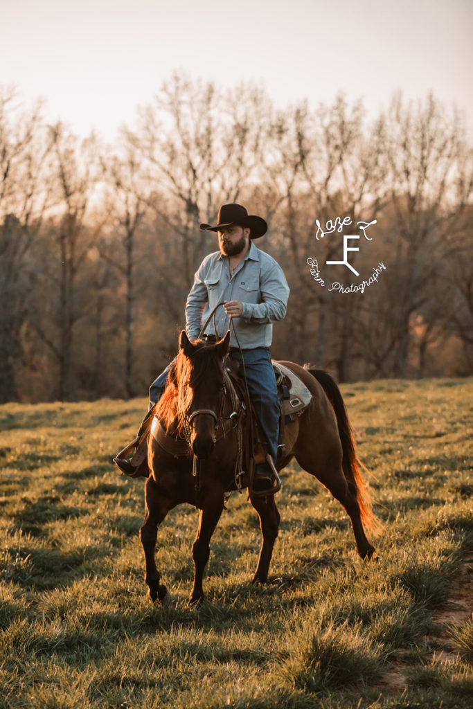 cowboy riding at sunset