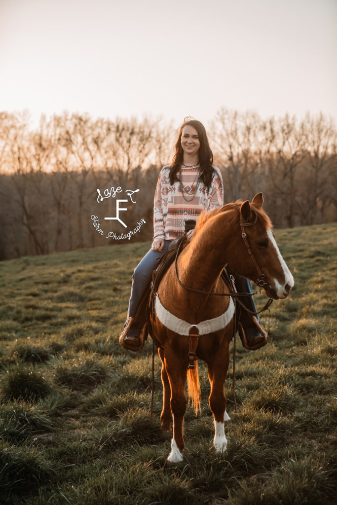 cowgirl riding at sunset