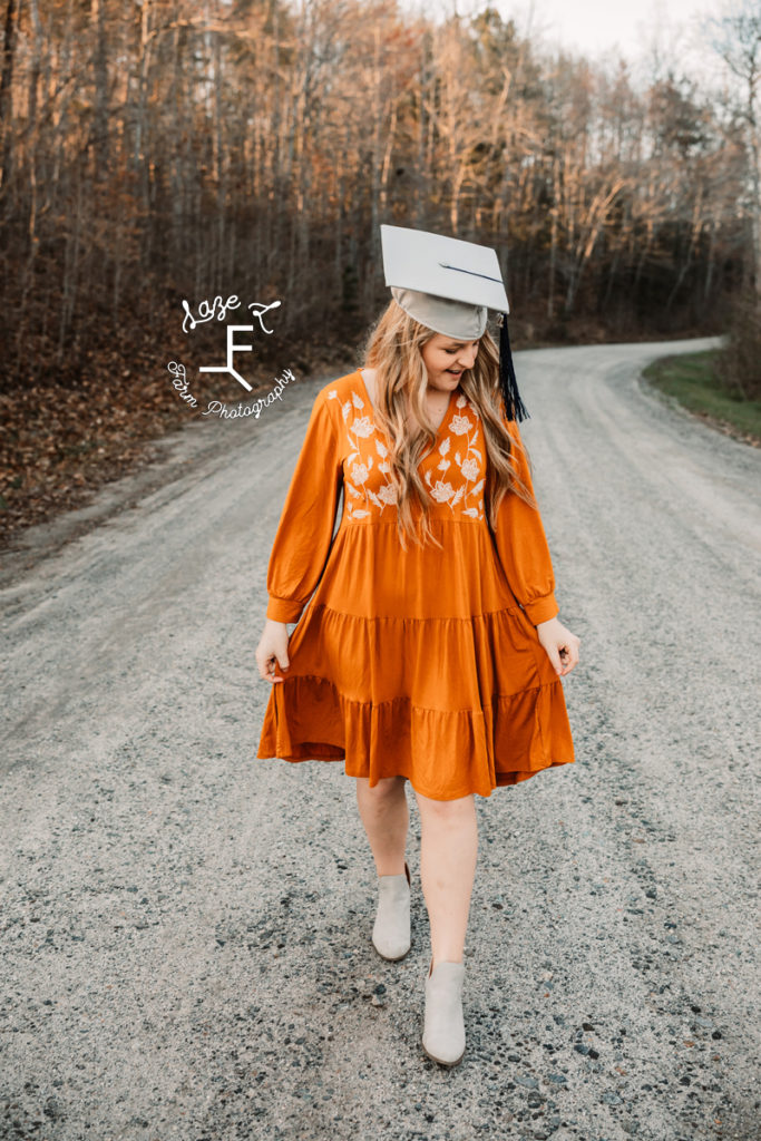 senior girl with cap on in orange dress