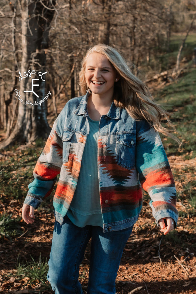 senior girl walking in Aztec print jacket