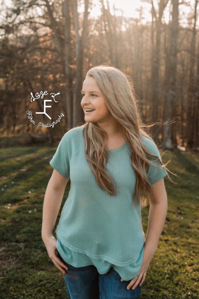 senior girl in blue shirt looking left