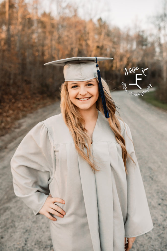 senior girl in gray cap and gown