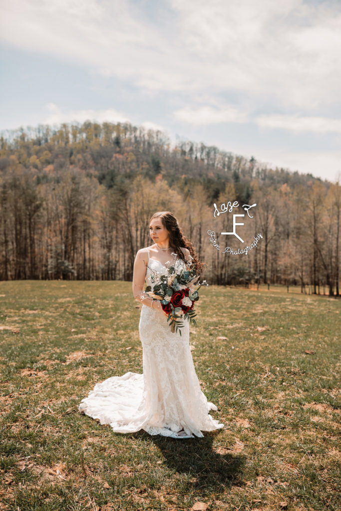 bride holding flowers looking left