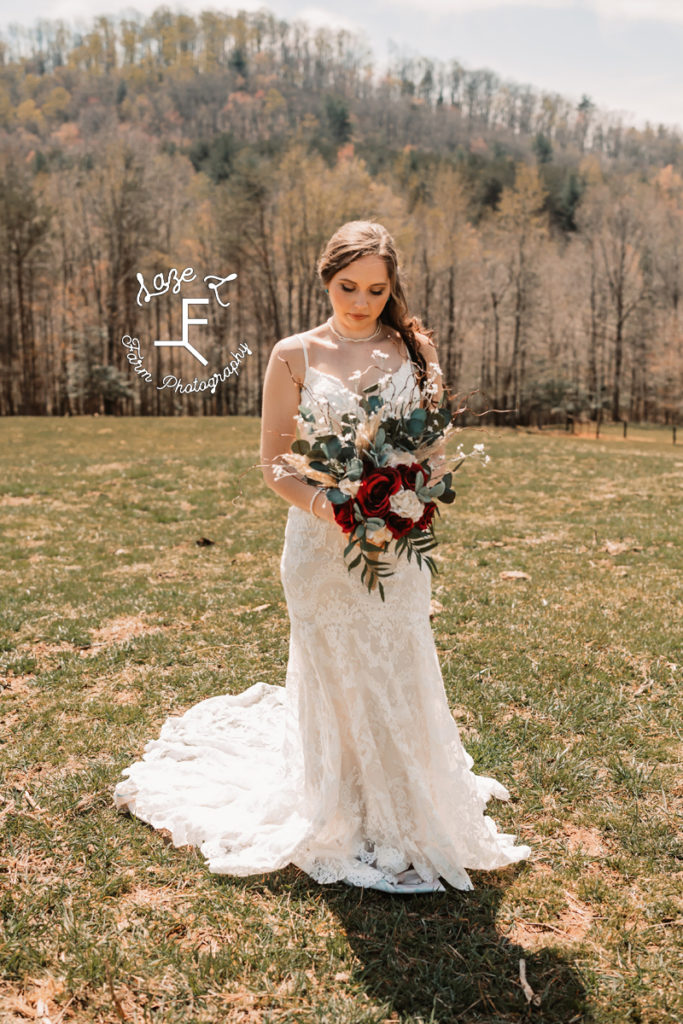 bride holding flowers looking down at flowers