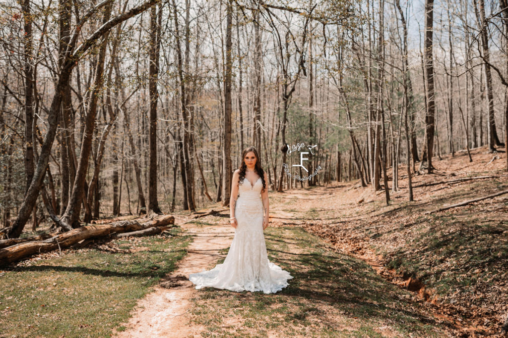 bride on a dirt road in the woods