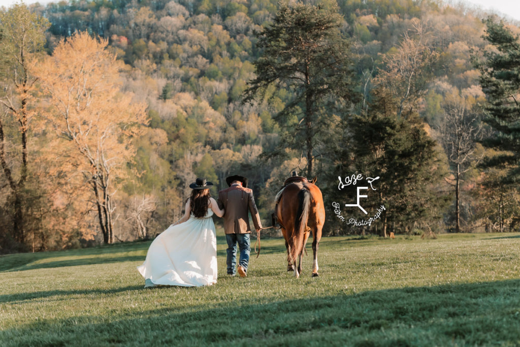 western couple walking away with horse