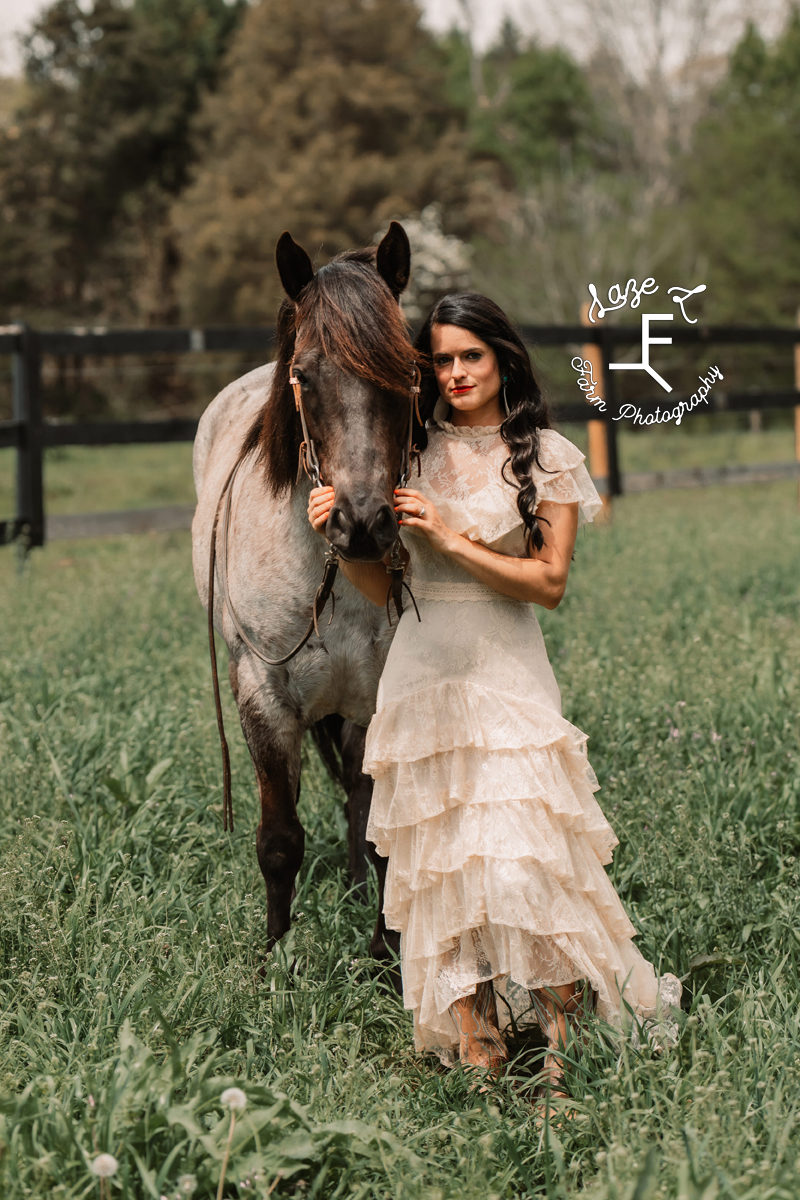 girl in vintage lace dress with blue roan horse