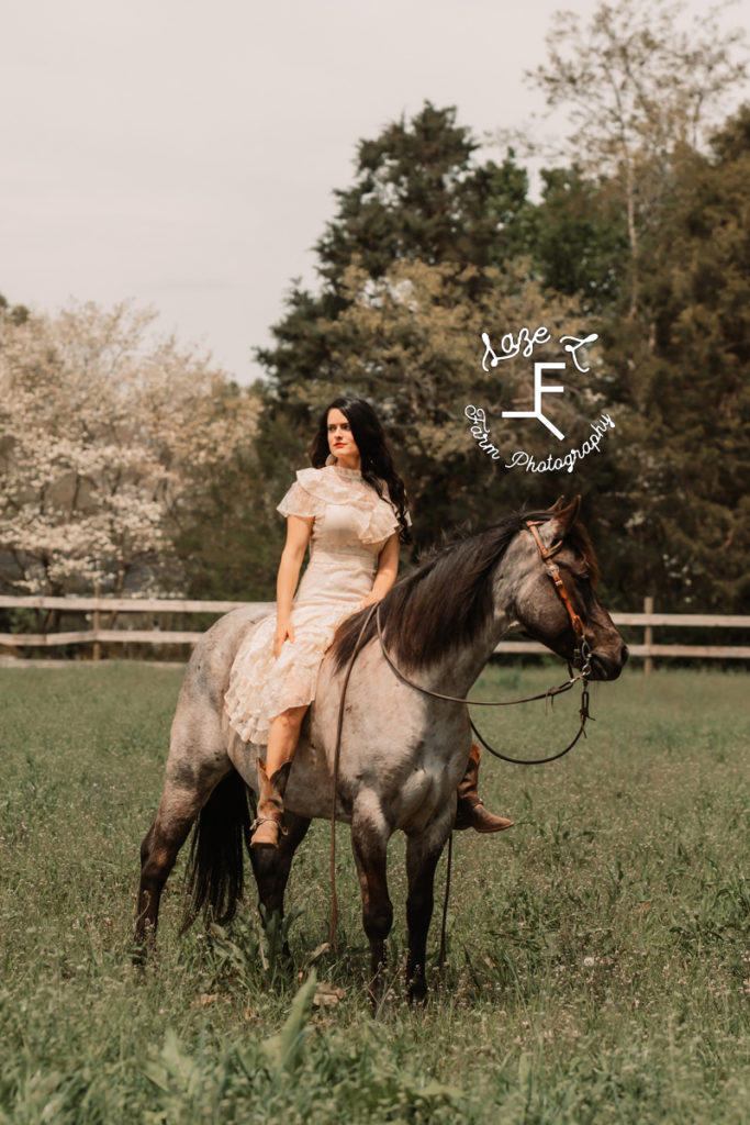 girl in vintage lace dress riding horse