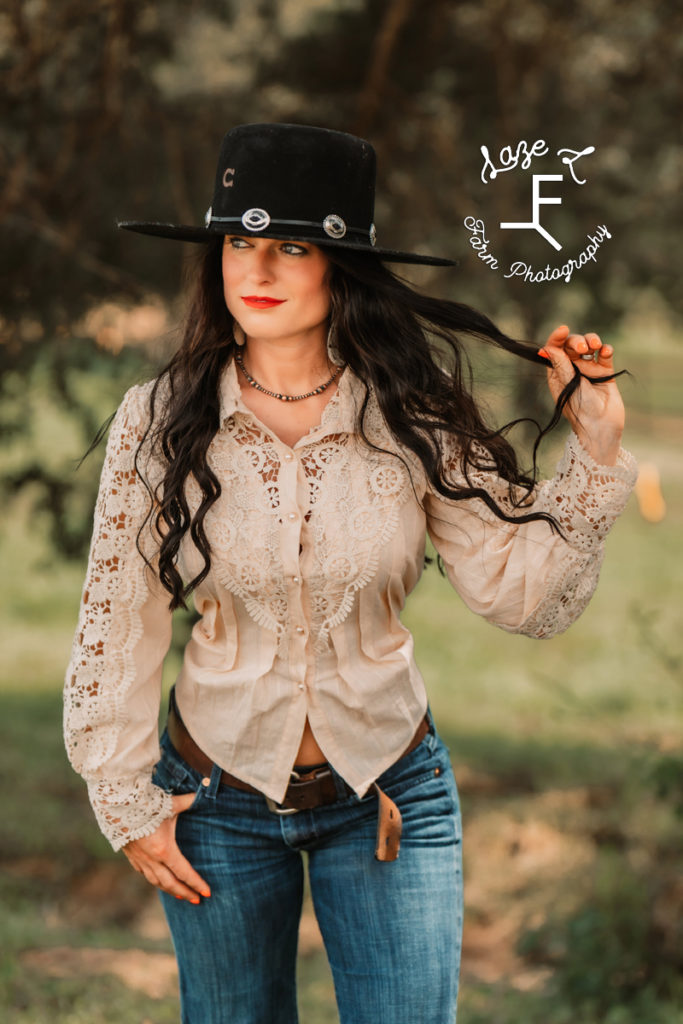 vintage cowgirl in jeans and lace shirt