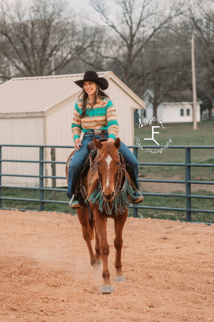 cowgirl riding sorrel horse