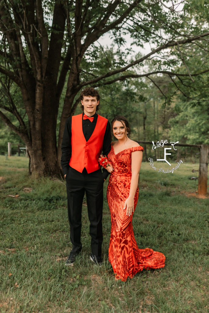 prom couple in orange and black