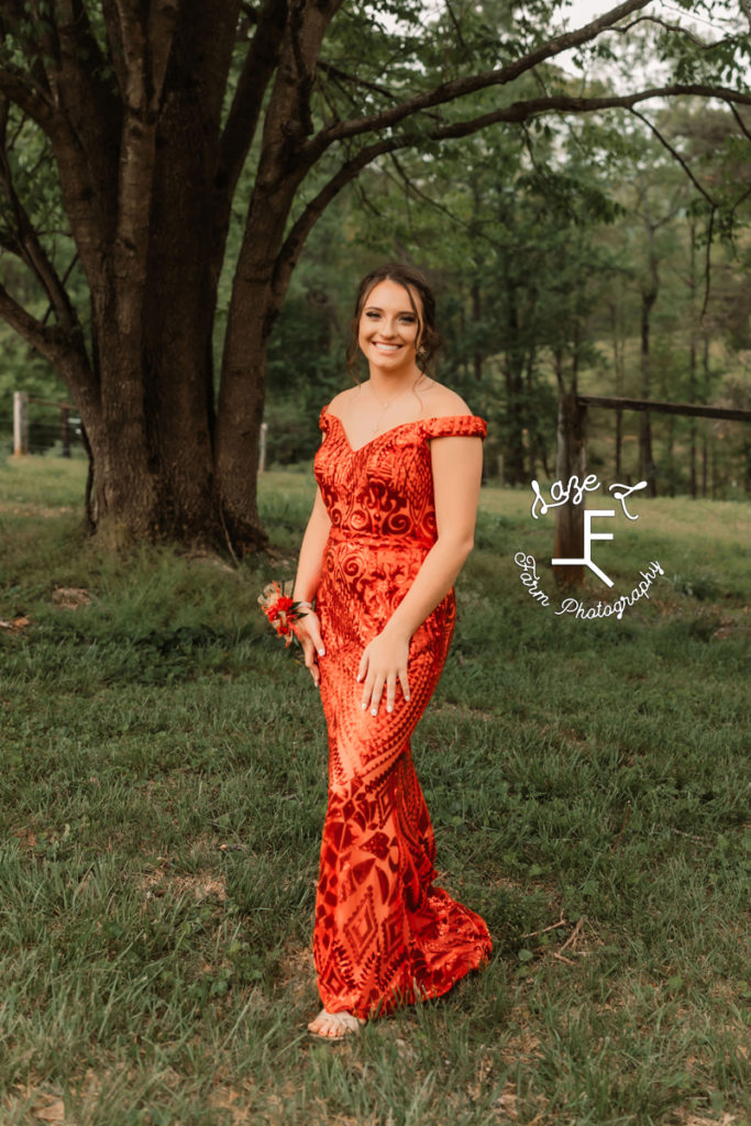 high school girl in orange prom dress