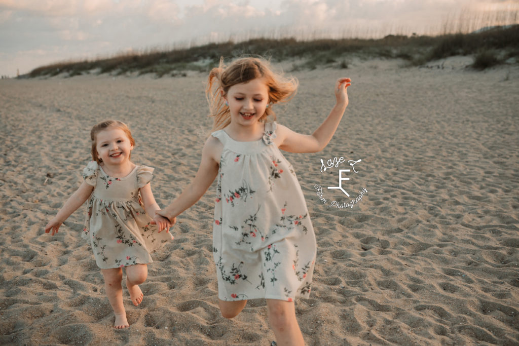 little girls running on the sand