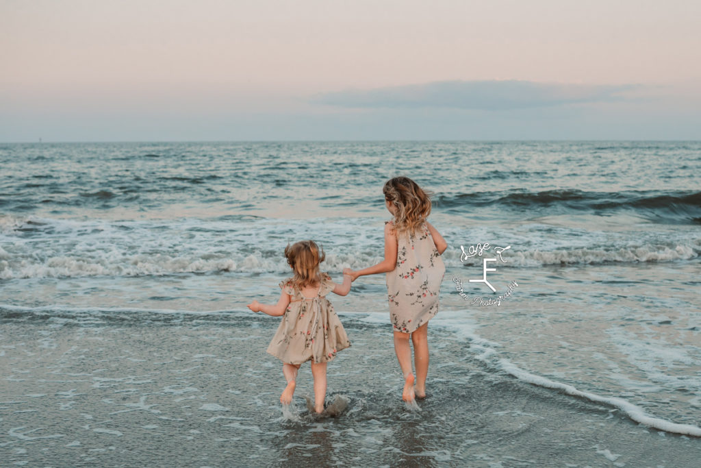 little girls playing in the ocean