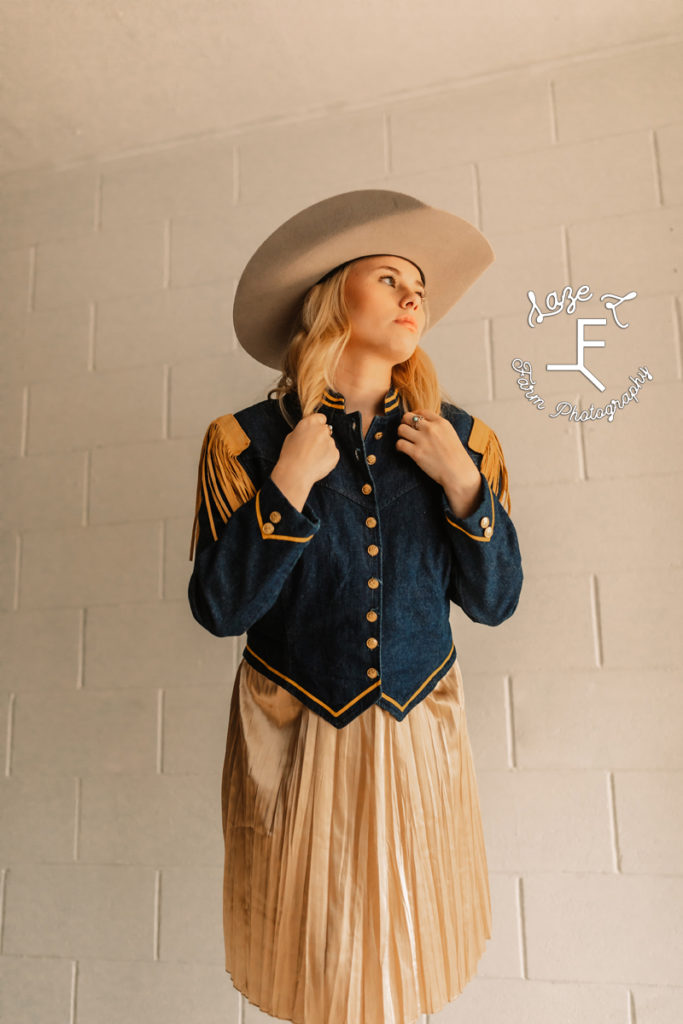 blonde cowgirl in vintage denim jacket with tank skirt