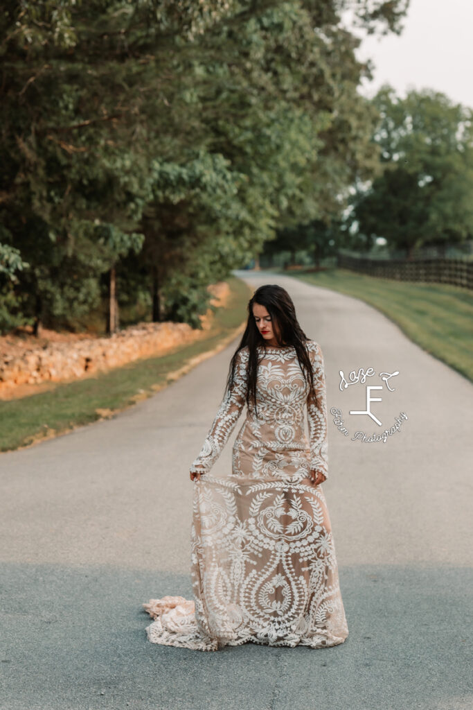 woman in lace wedding dress on long driveway