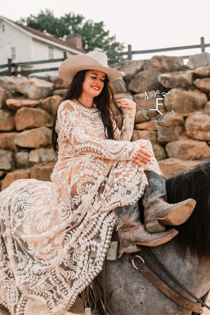 cowgirl sitting on horse in lae dress