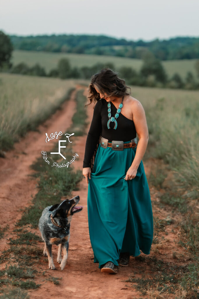 girl wearing teal skirt with blue heeler dog