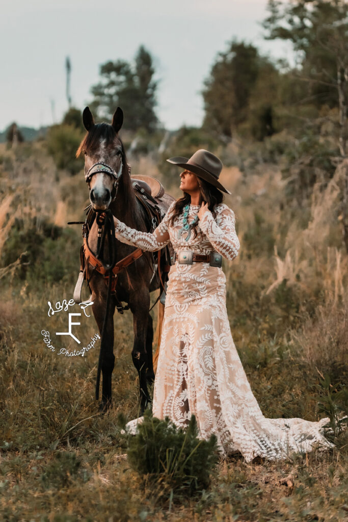 Cowgirl in white lace dress with 2 year old horse