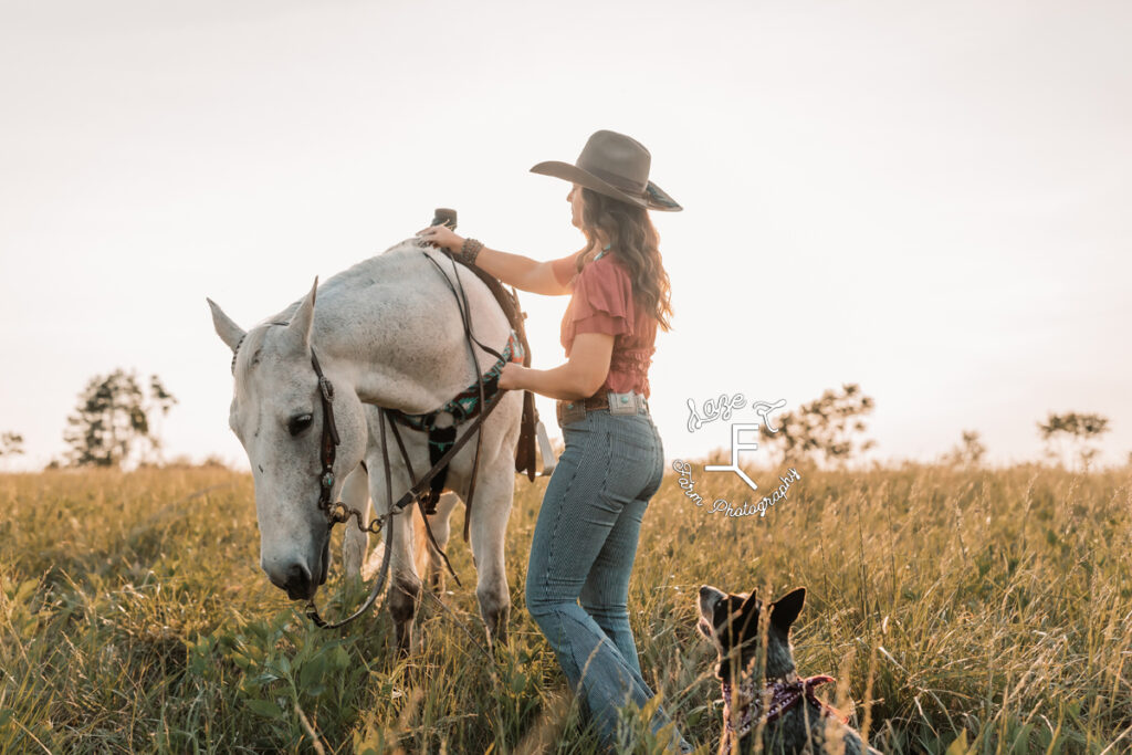 cowgirl with gray horse and dog