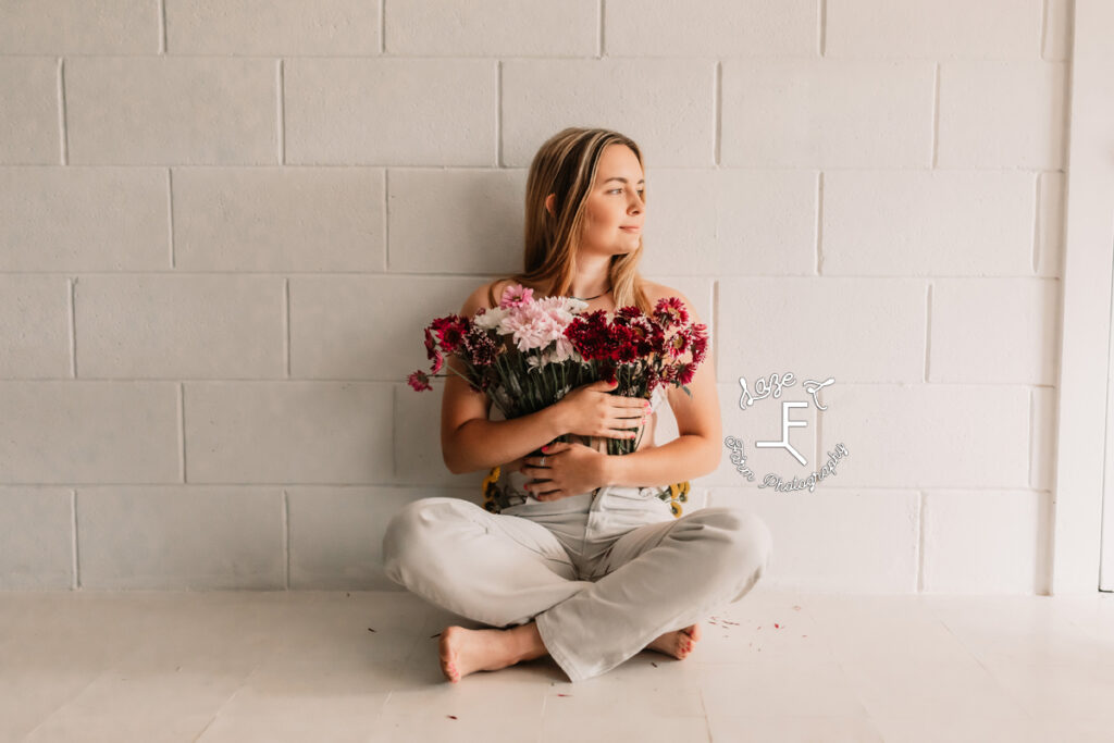 girl sitting in flower pants