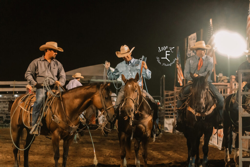 cowboys on horseback talking