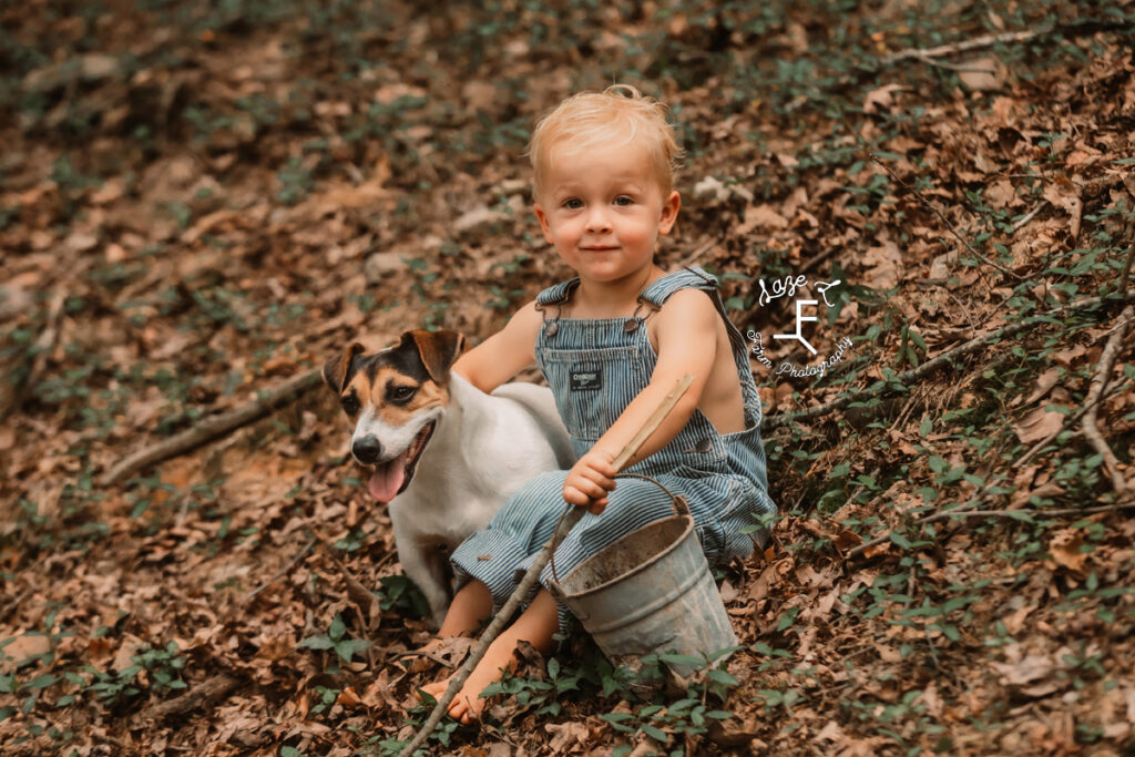 little brother in overalls with his dog