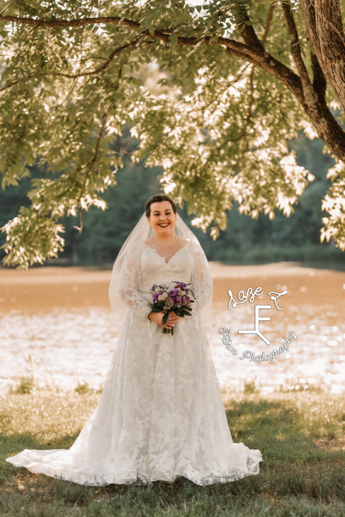 Bride at the lake under a tree