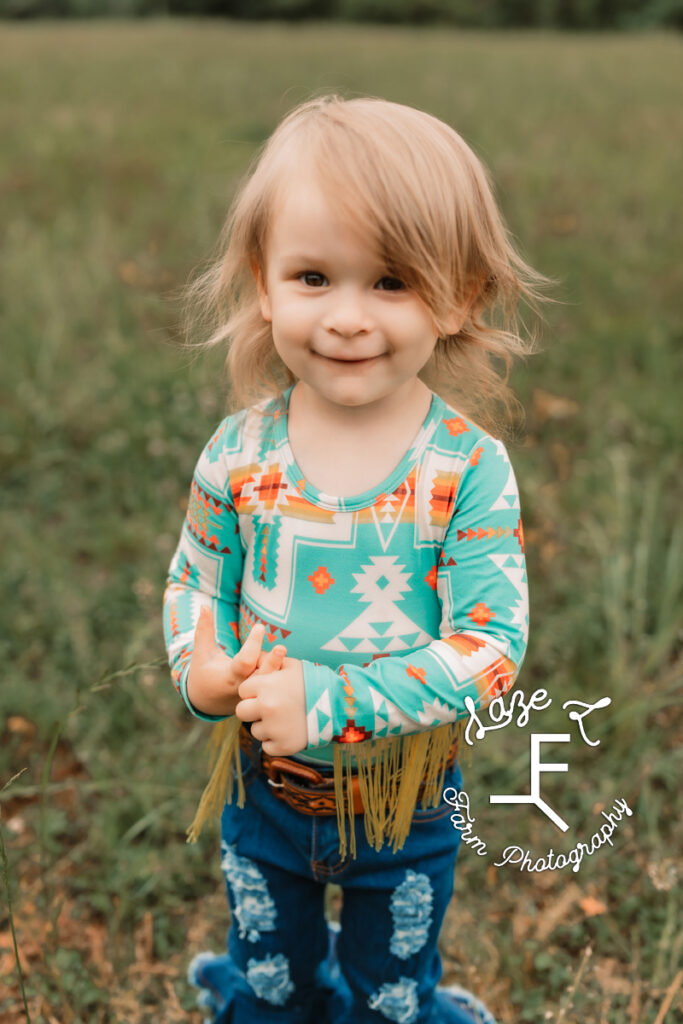 little girl in Aztec print shirt with fringe