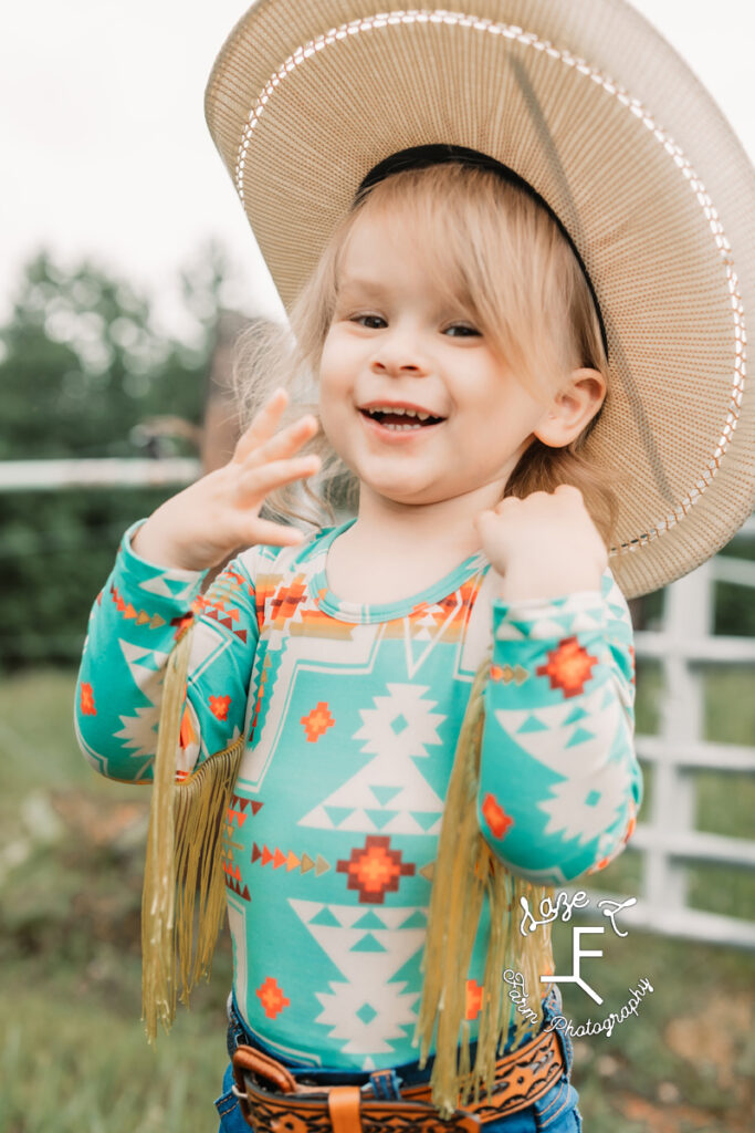 little cowgirl flipping her hair back