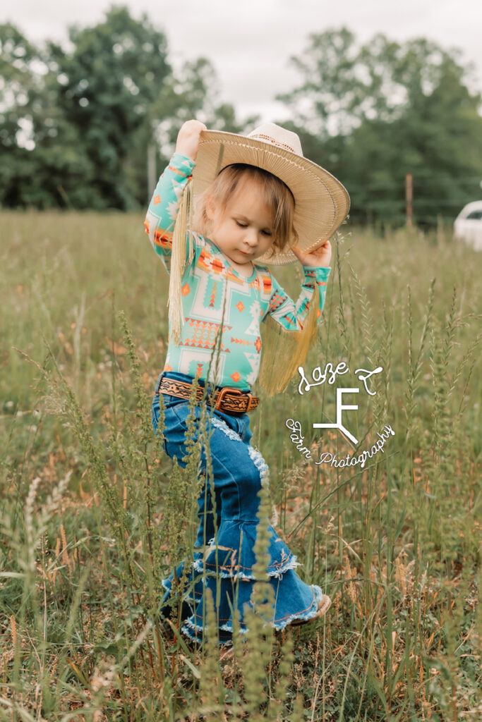 little cowgirl marching through pasture