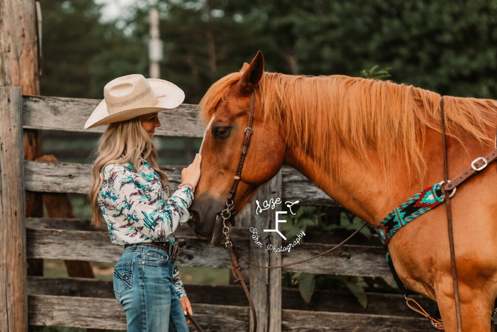 Cowgirl riding palomino through field