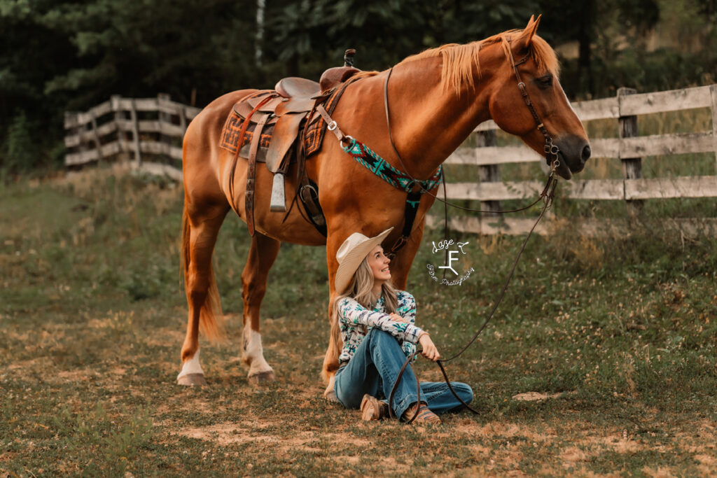 cowgirl in floral dress riding palomino through field
