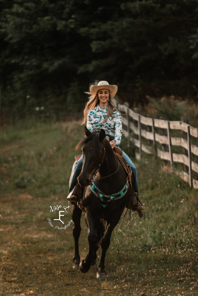 cowgirl riding a black draft cross