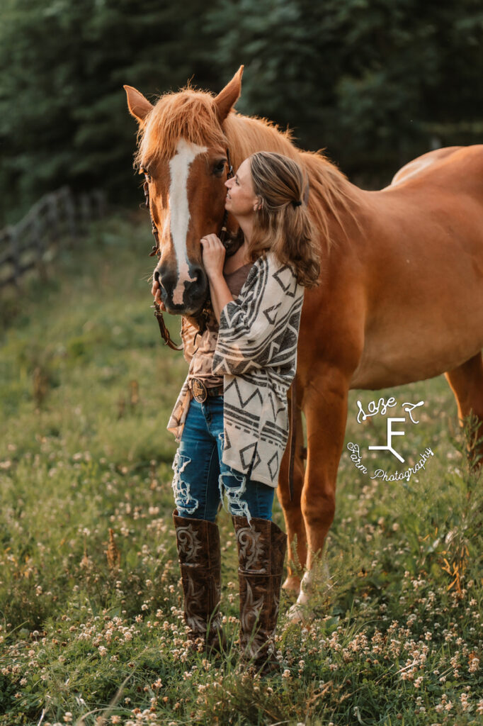girl in brown boots loving horse