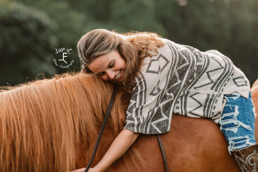 girl loving horse from on his back