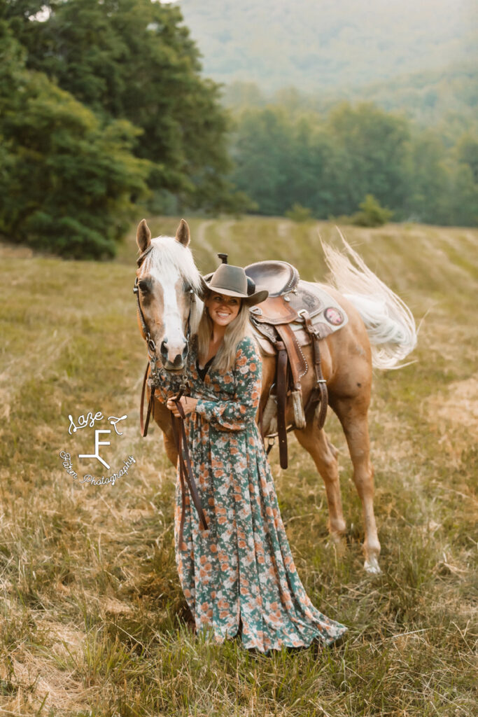cowgirl standing with palomino in floral dress