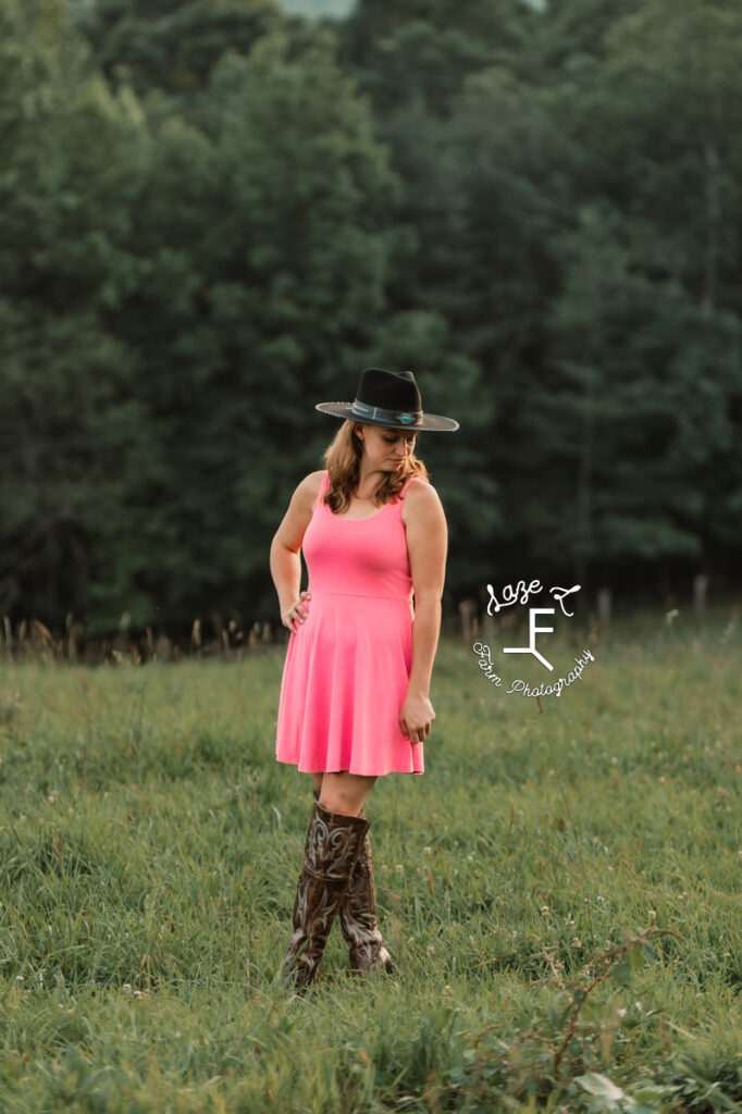 cowgirl in black hat and pink dress