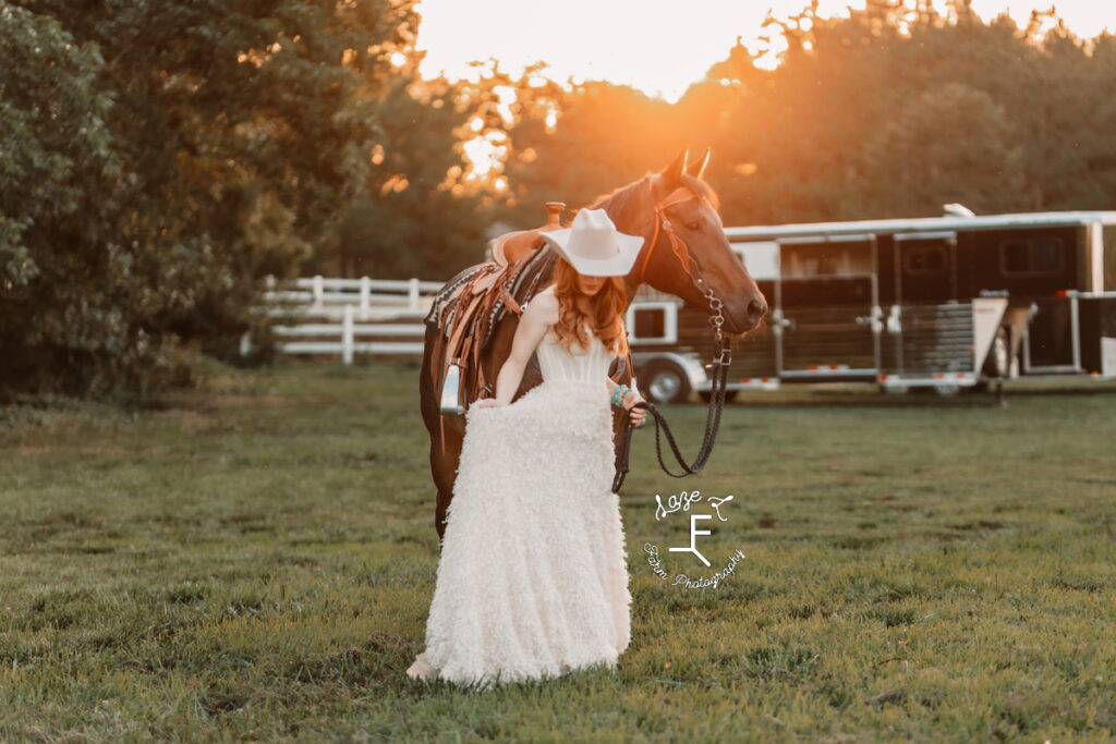 cowgirl in white dress with bay roan