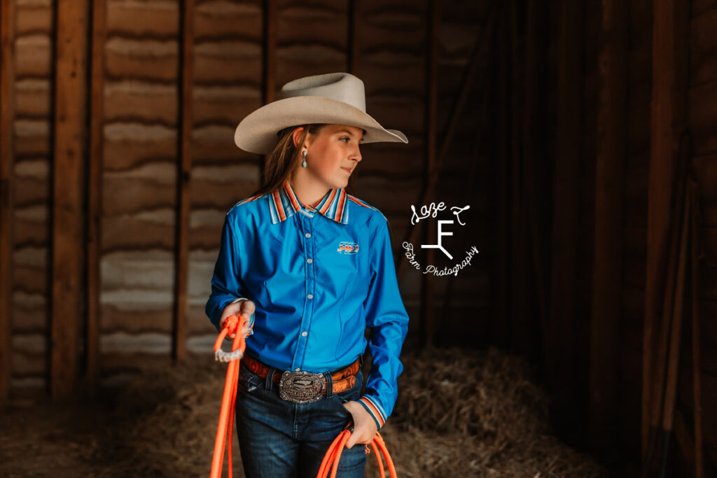 cowgirl in blue rocket donkey button down with orange rope