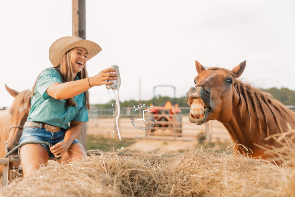 cowgirl holding an overflowing beer with horse smiling