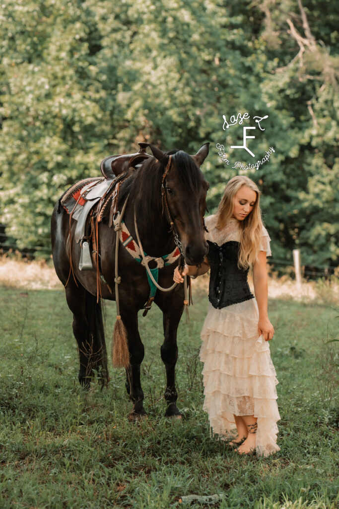 blonde model in vintage dress with black horse