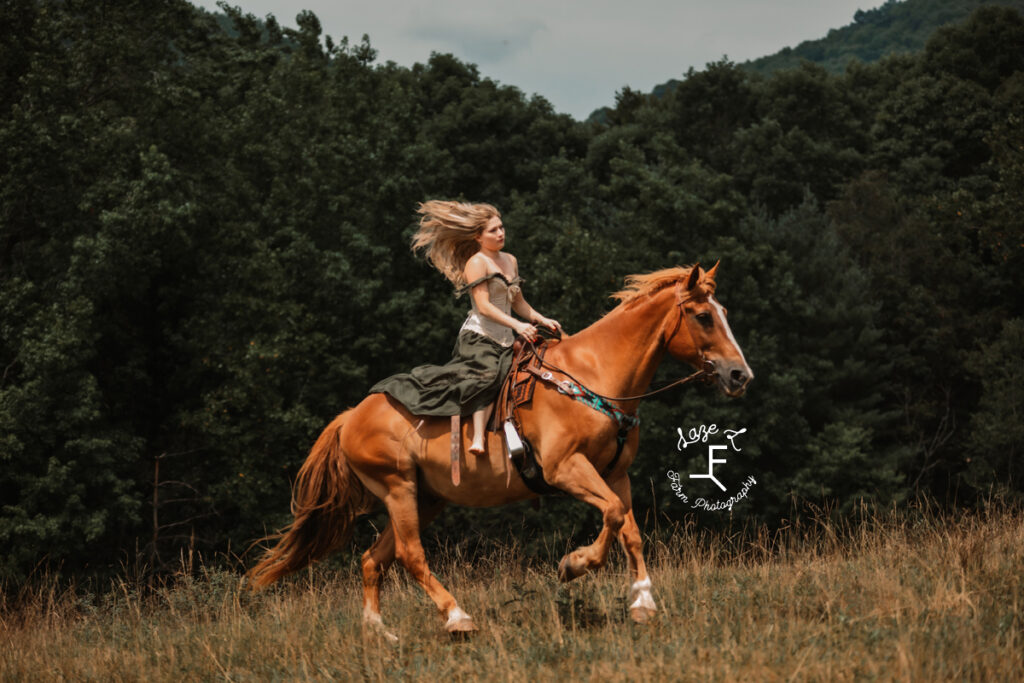 model in green dress loping on brown horse
