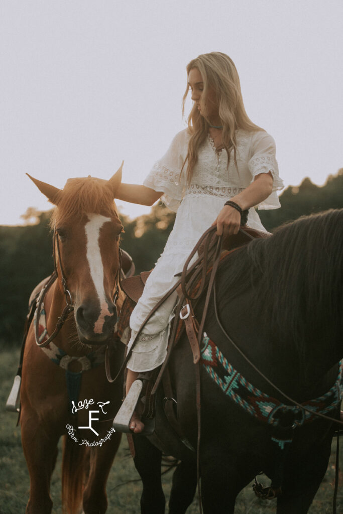 girl in white dress riding black horse ponying Belgium