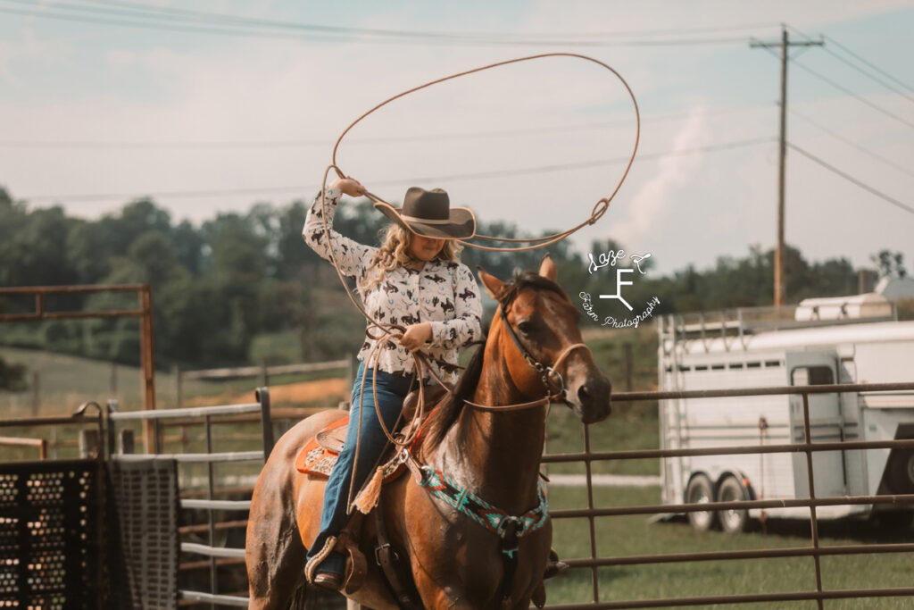 cowgirl roping on horseback