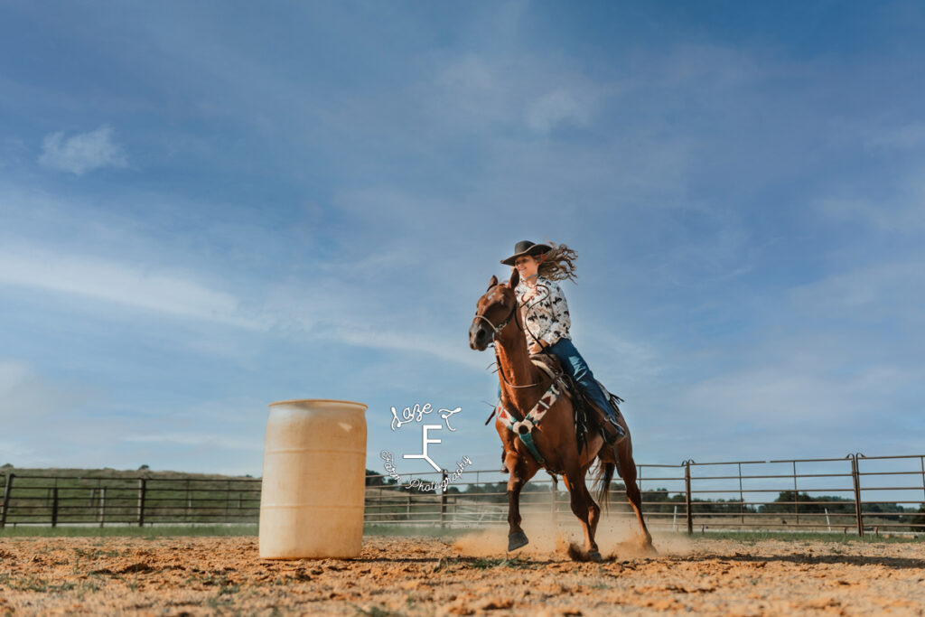 cowgirl riding around barrel