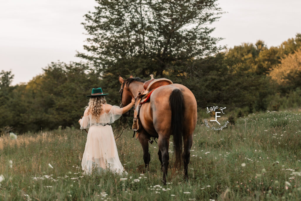 cowgirl walking with horse in white dress