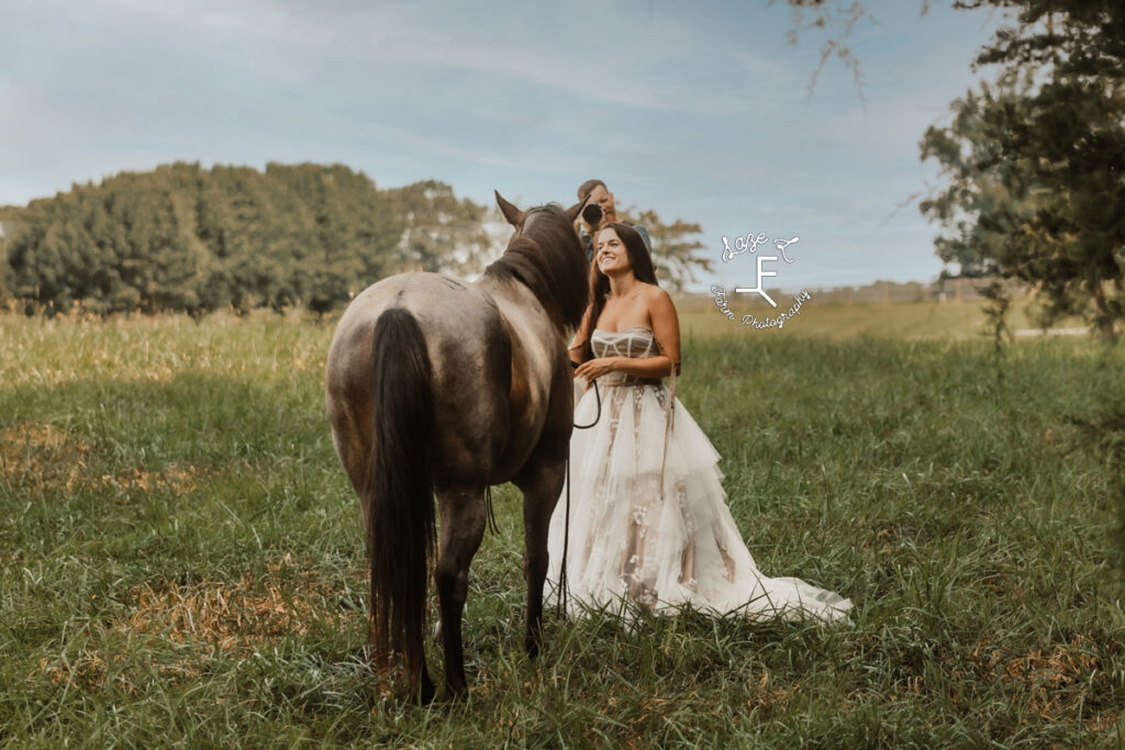 Model with blue roan horse with other photographer in the background