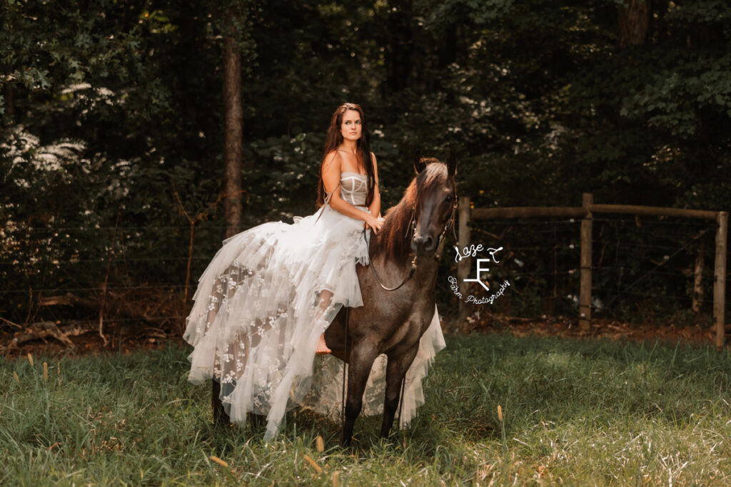 model sitting on horse