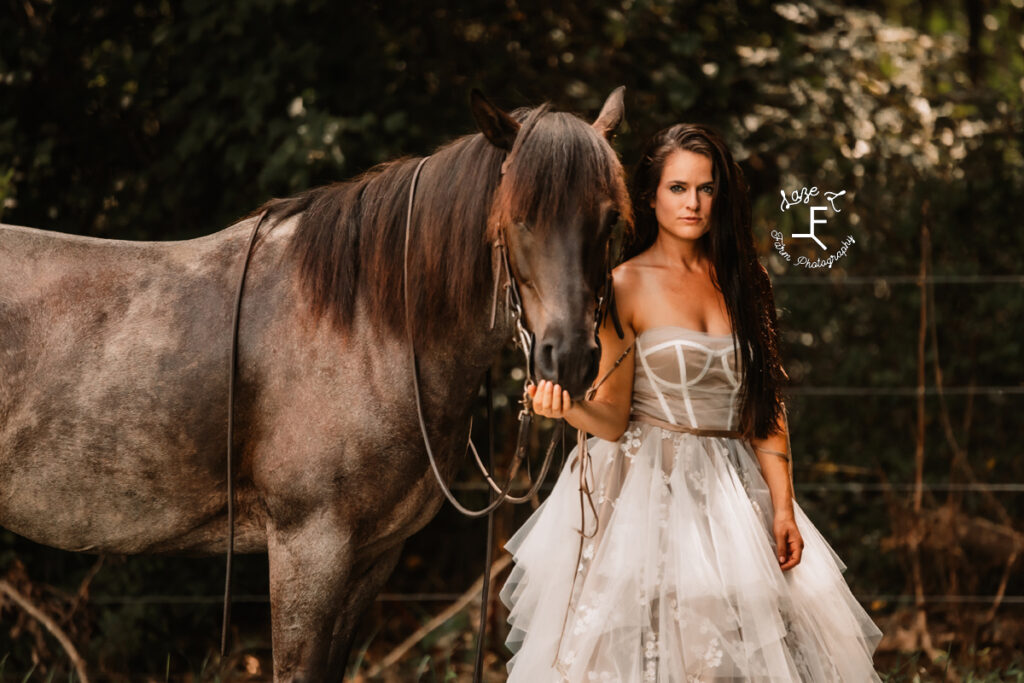 model standing with horse